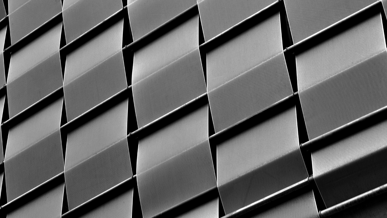 Abstract background. Modern geometric futuristic architecture in the city in an urban environment. Curves in the details of architecture.